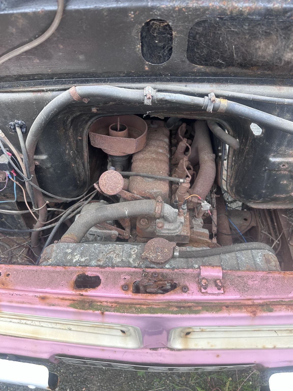 Close view of a rusty Bedford CF engine before mechanical restoration