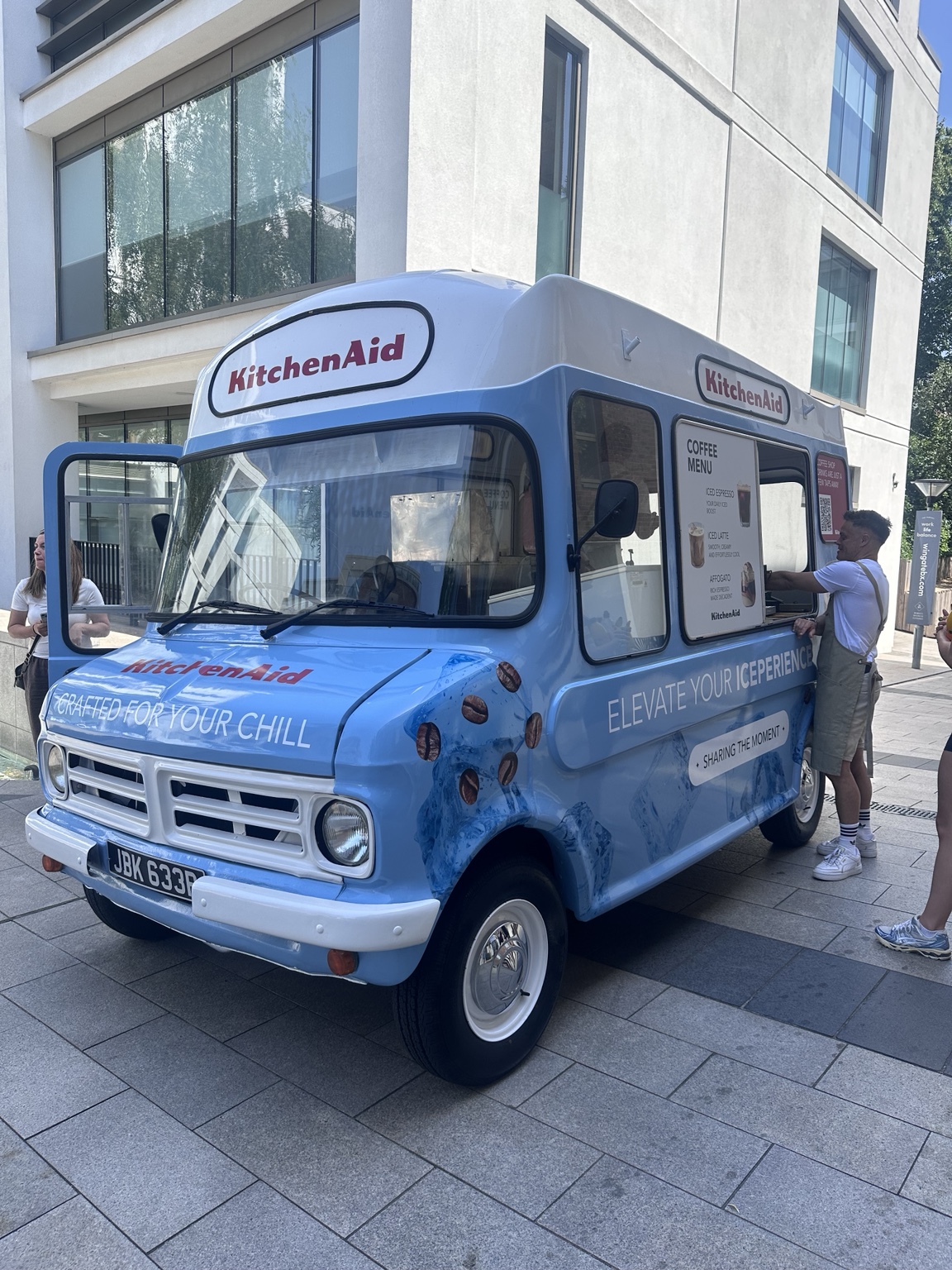 Percy serving at a city event in a KitchenAid wrap