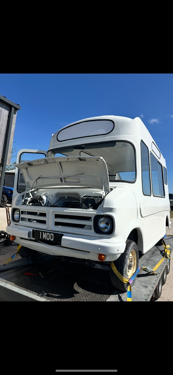 Freshly painted white Bedford CF with bonnet open during restoration